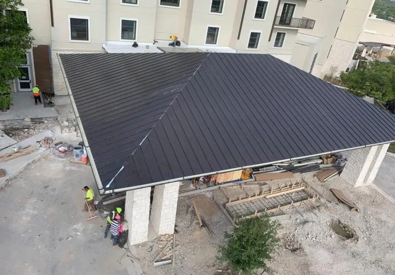 Metal roofing installation team working on a commercial building in Kalifornsky